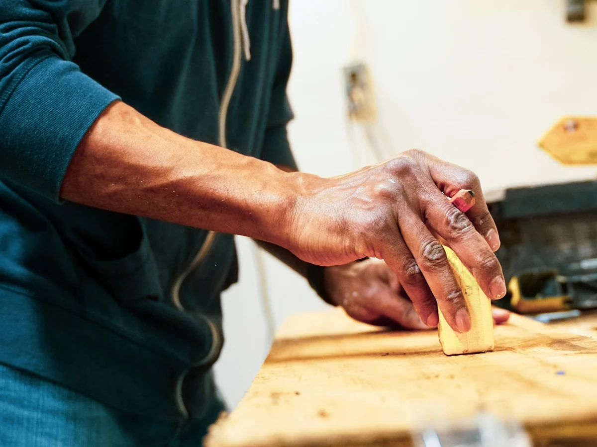 Hand finishing a wooden board surface